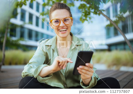 happy business woman in green blouse and eyeglasses happy business woman in green blouse and eyeglasses 112737807