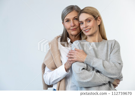 Mother and daughter looking happy and confident Mother and daughter looking happy and confident 112739670