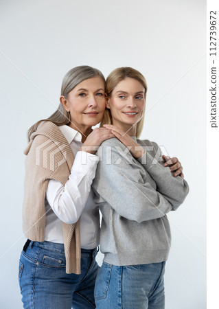 Mom and daughter standing close and looking peaceful Mom and daughter standing close and looking peaceful 112739672