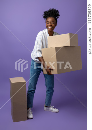 African american curly-haired girl with boxes on a violet background African american curly-haired girl with boxes on a violet background 112739899
