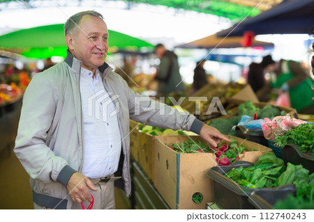Middle aged man buying radish 112740243