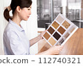 A woman looking at flooring samples 112740321