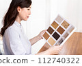 A woman looking at flooring samples 112740322