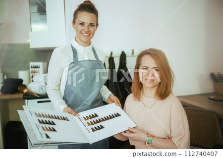 woman hair salon worker in modern hair studio woman hair salon worker in modern hair studio 112740407