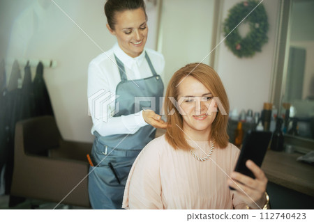 40 years old woman hairdresser in modern beauty studio 112740423