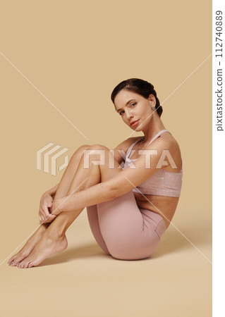 Portrait of fit woman in tight sportswear doing yoga 112740889