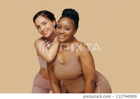 Studio portrait of happy excited diverse female friends Studio portrait of happy excited diverse female friends 112740909