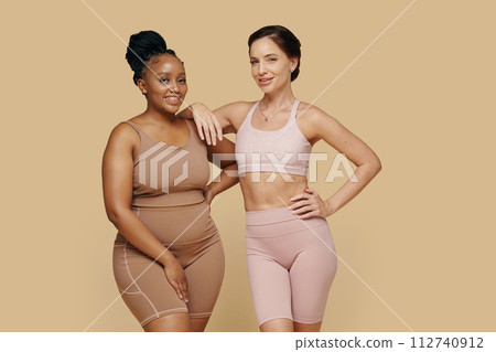 Happy women with different body types standing next to each other 112740912