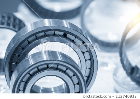 Close up scene the cylindrical ball bearing parts in the light blue scene. 112740932