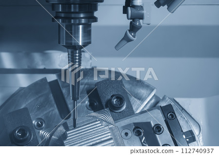 The 5-axis CNC milling machine  cutting the automotive part with solid ball end mill tool. The 5-axis CNC milling machine  cutting the automotive part with solid ball end mill tool. 112740937