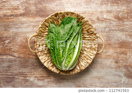 Romaine lettuce in a basket, top down view 112741563