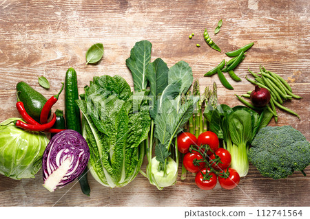 Vegetables background. Various vegetables on kitchen table. Clean eating, healthy food concept, flat lay, top down view 112741564