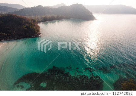 Aerial Beach and coconut trees on a calm island in the morning Aerial Beach and coconut trees on a calm island in the morning 112742082