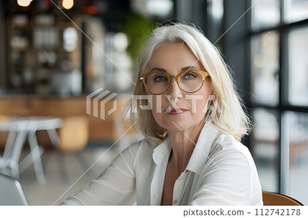 AI-generated content. Age diversity at workplace - elderly professional at her workplace 112742178