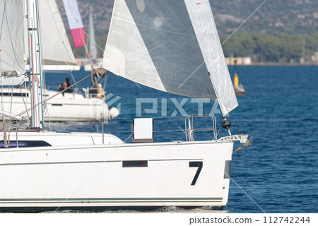 Sailing yachts with white sails in the sea Sailing yachts with white sails in the sea 112742244