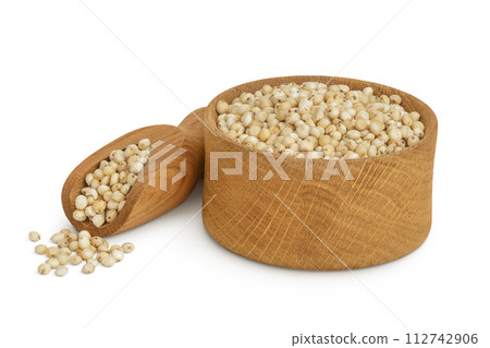 Sorghum seeds in wooden bowl and scoop isolated on white background with full depth of field. Sorghum seeds in wooden bowl and scoop isolated on white background with full depth of field. 112742906