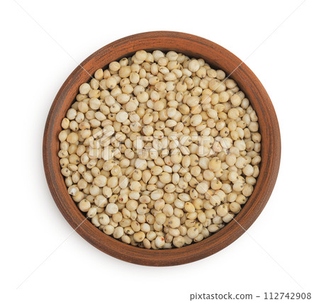 Sorghum seeds in ceramic bowl isolated on white background. Top view. Flat lay. 112742908