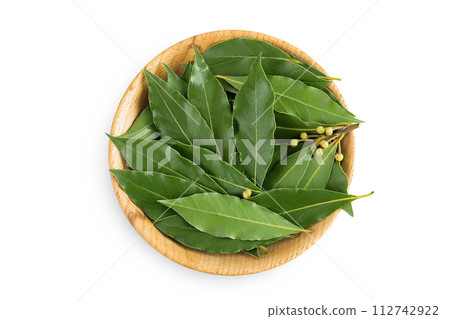 Fresh Laurel leaves in wooden bowl isolated on white background. Green bay leaf. Top view. Flat lay. 112742922