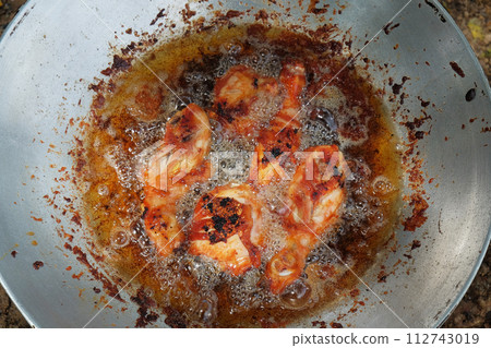 Delicious Fried Chicken in a Sizzling Hot Pan with Skillful Chef Expertise Delicious Fried Chicken in a Sizzling Hot Pan with Skillful Chef Expertise 112743019