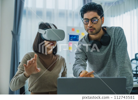 Asian and Indian developer program coding sent to virtual reality headset to implement ai project at office Asian and Indian developer program coding sent to virtual reality headset to implement ai project at office 112743581