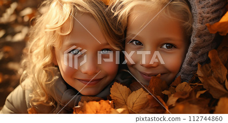 Portrait of two children, a boy and a girl, with autumn leaves 112744860