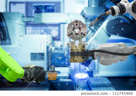 Industrial welding robot working with metal part from gripping robot on smart manufacturing factory, industry 4.0 Industrial welding robot working with metal part from gripping robot on smart manufacturing factory, industry 4.0 112745460