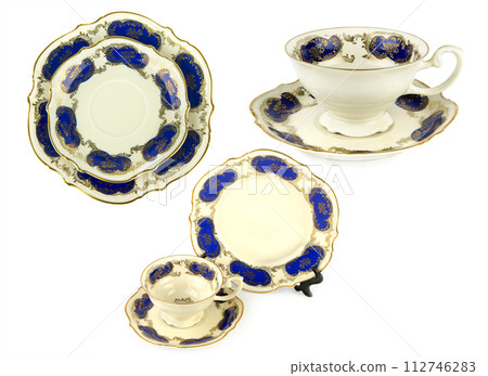 Porcelain vintage cup saucer and plate isolated on white. Collage. Vintage Bavarian teaware. Porcelain vintage cup saucer and plate isolated on white. Collage. Vintage Bavarian teaware. 112746283