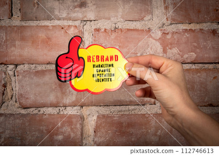 REBRAND. Sticky note with text on a red brick background 112746613