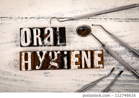 ORAL HYGIENE. Dental instruments on a white wooden background ORAL HYGIENE. Dental instruments on a white wooden background 112746616