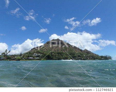 Beach and Makalei Beach Park with seawall, coconut trees, homes, and Diamond Head Crater 112746921