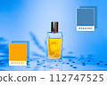 Glass golden perfume bottle on a steelblue background with shadows of plants. Samples of colors 4682B4 and FFA500. Colors template with cosmetics 112747525