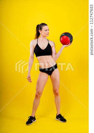 Strong woman does exercise with med ball slams. Strength and motivation. Strong woman does exercise with med ball slams. Strength and motivation. 112747683
