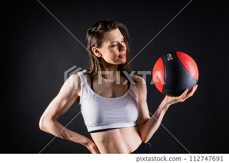 Strong woman does exercise with med ball slams. Strength and motivation. 112747691
