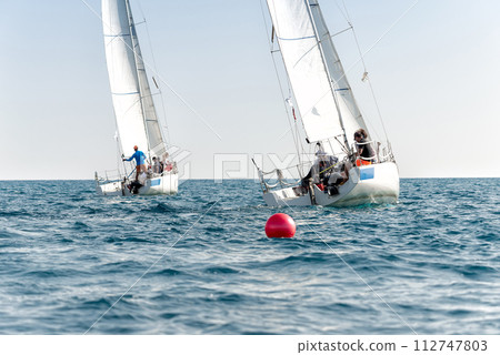 Yachts in light wind during regatta competition in open sea Yachts in light wind during regatta competition in open sea 112747803