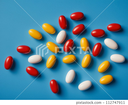 Close-up of a set of colorful pills on a blue background 112747911