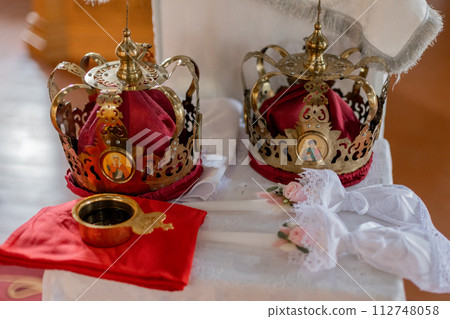 Orthodox wedding crowns and icons, essential in traditional marriage ceremonies. Representative of unity and spiritual commitment Orthodox wedding crowns and icons, essential in traditional marriage ceremonies. Representative of unity and spiritual commitment 112748058