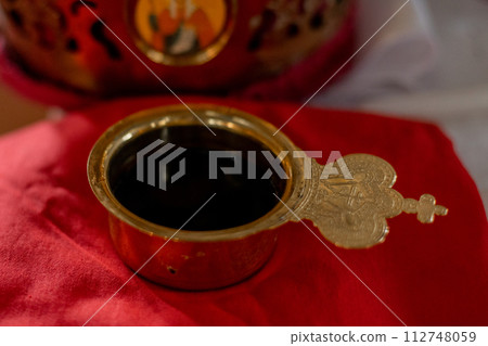Orthodox wedding crowns and icons, essential in traditional marriage ceremonies. Representative of unity and spiritual commitment 112748059