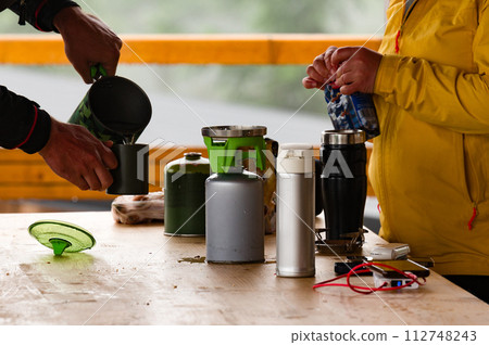 Tourists prepare coffee using gas cylinders. 112748243