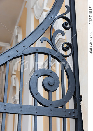Vintage black forged gate decoration details, close-up Vintage black forged gate decoration details, close-up 112748374