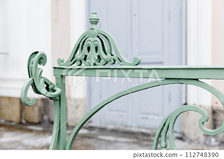 Green decoration design elements of an outdoor vintage forged railings 112748390