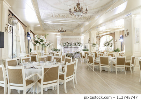 Elegant wedding reception venue with sophisticated decor and floral arrangements 112748747