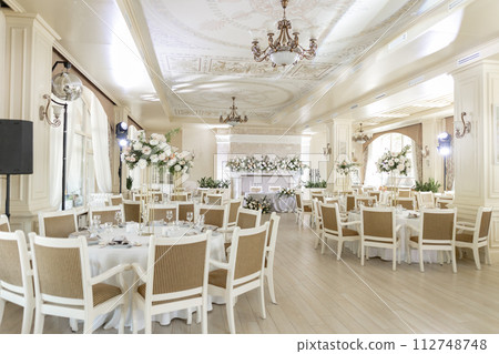 Elegant wedding reception venue with sophisticated decor and floral arrangements 112748748