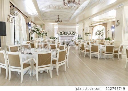 Elegant wedding reception venue with sophisticated decor and floral arrangements 112748749