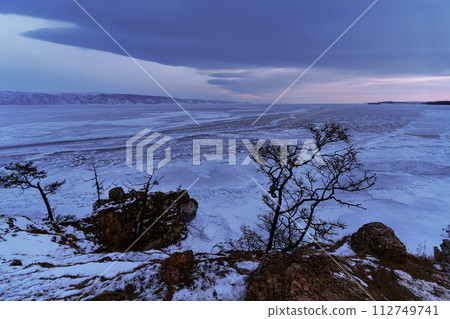 Beautiful winter landscape with mountains and Lake Baikal in Siberia at dawn. Natural background with copy space. Travel and vacations concept. 112749741