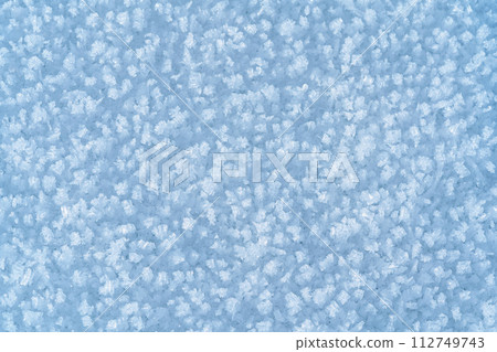 Ice hummocks covered in snow on Baikal Lake. Transparent blue ice floe. Natural background. Great backdrop for your design with copy space. Top view. 112749743
