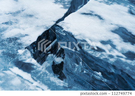 Ice hummocks on Baikal Lake. Transparent blue ice floe. Natural background. Great backdrop for your design with copy space. 112749774