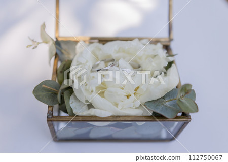 wedding gold rings on a ceremony table 112750067
