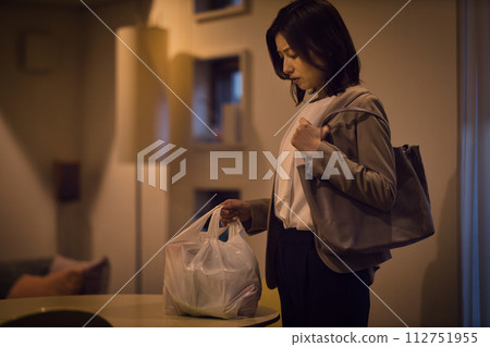 Night routine of a business woman putting ingredients on the table Night routine of a business woman putting ingredients on the table 112751955
