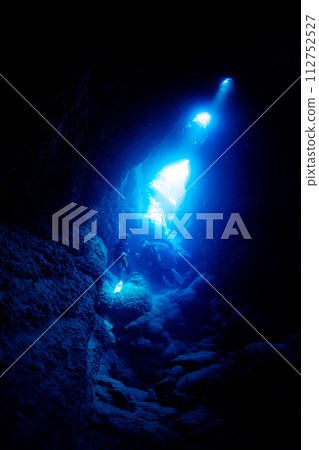 Diver looking up from inside a cave Diver looking up from inside a cave 112752527