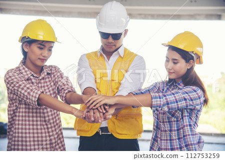 Group of multiracial people Teamwork meeting join hands Engineer Manager Foreman fist bump together. Close up diversity engineer people hands partner teams. Business connection team join partnership Group of multiracial people Teamwork meeting join hands Engineer Manager Foreman fist bump together. Close up diversity engineer people hands partner teams. Business connection team join partnership 112753259